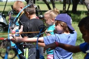 boys shooting bows and arrows